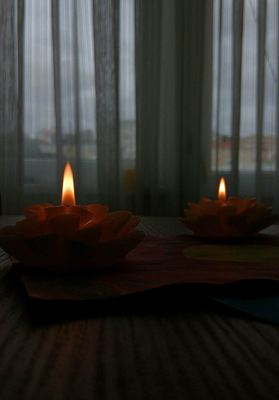 A hand-poured Wick & Co soy candle glowing on a table